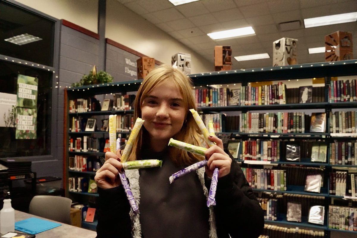 Gretchen Esterly poses holding tampons for her club the Hayes Period Project.