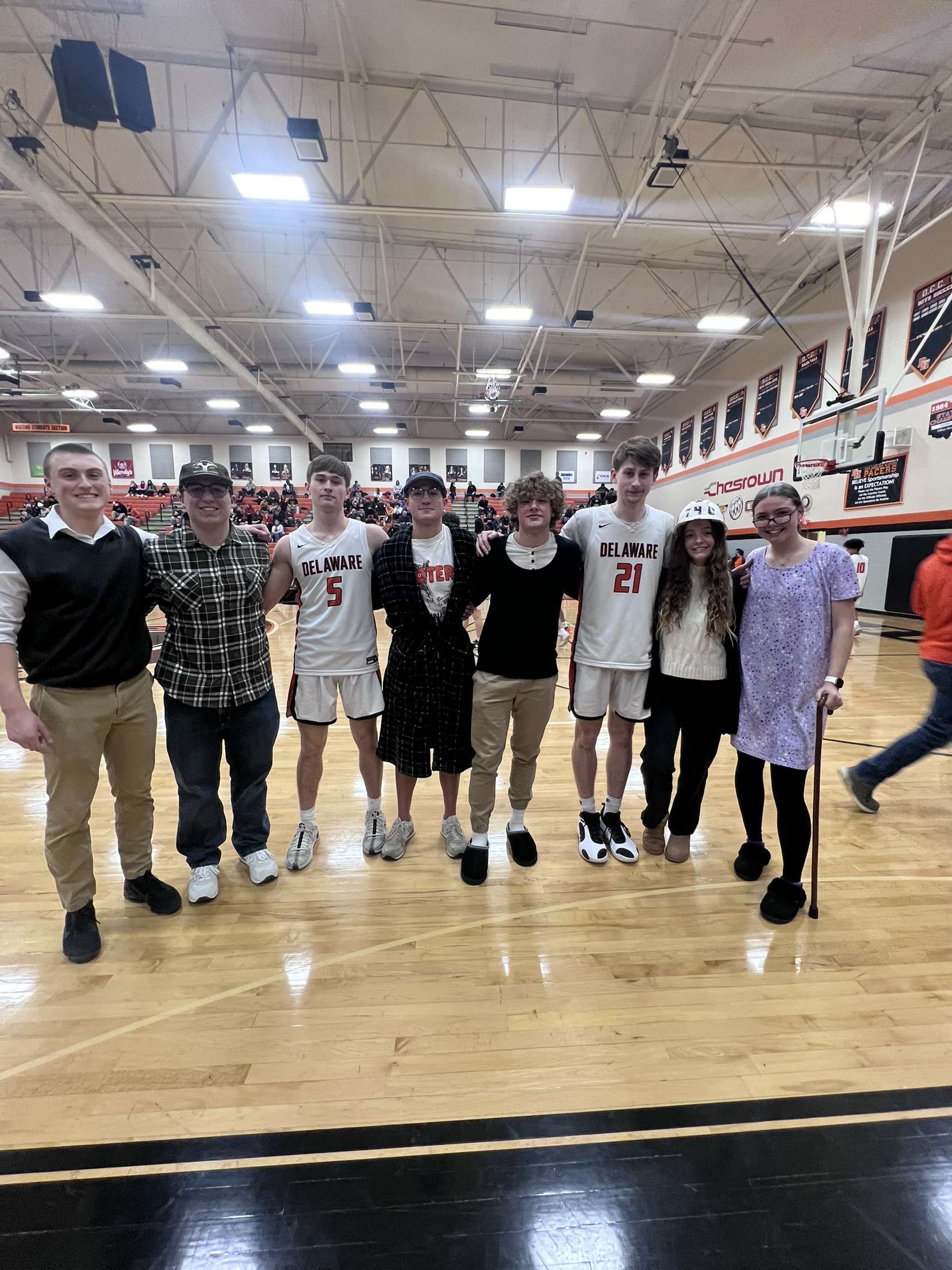 The current student section leaders and new leaders gather for a picture after the new leaders are announced.