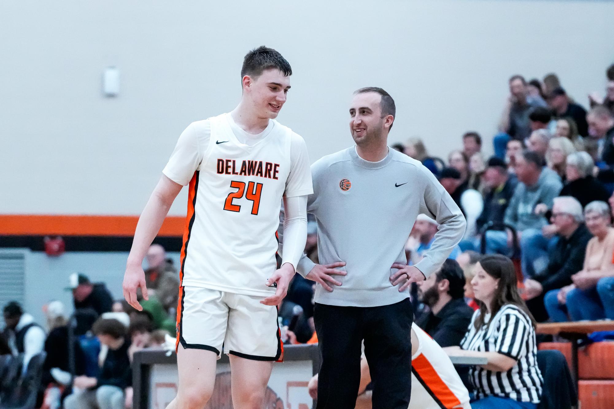 Coach Vincenzo talks with player Landon Vanderwarker during a game. 