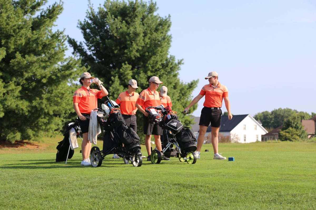 The Pacers talk gameplan on the third hole. The Pacers went on to shoot 317 as a team at Chapel Hill Golf Course.