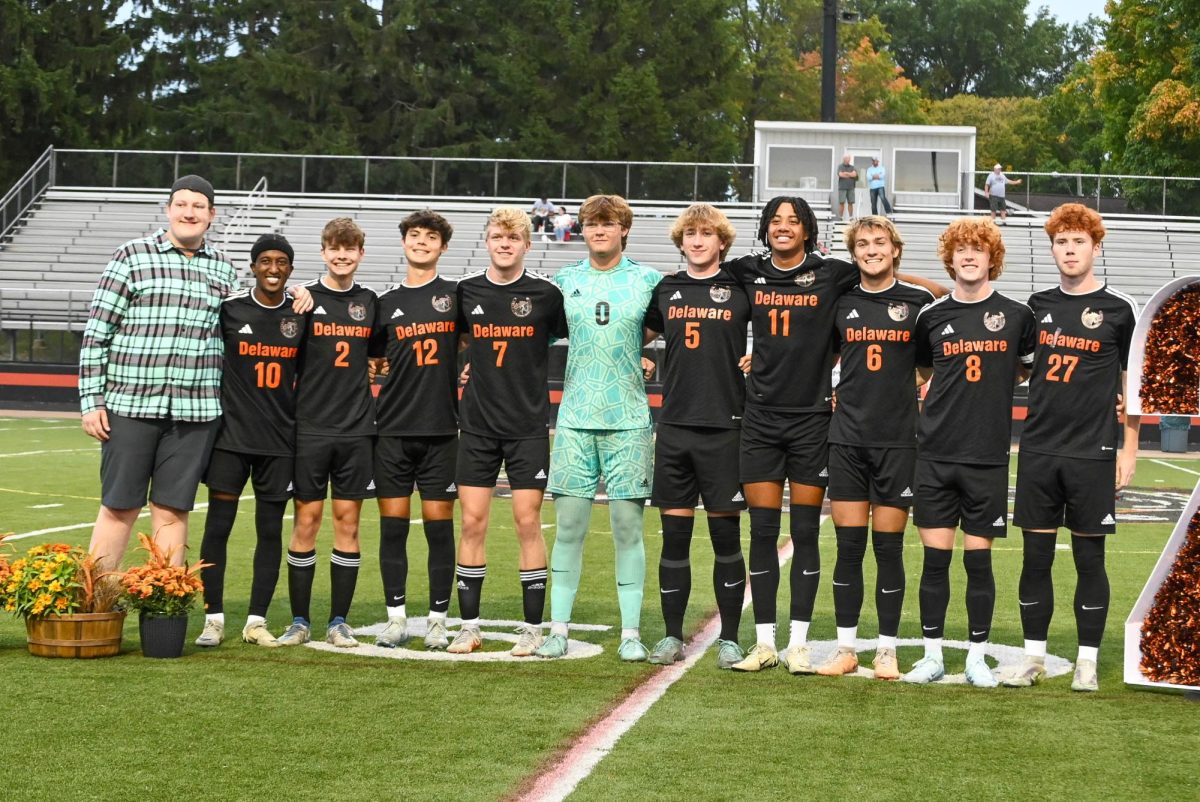 Senior players pose with each other before the start of the game.