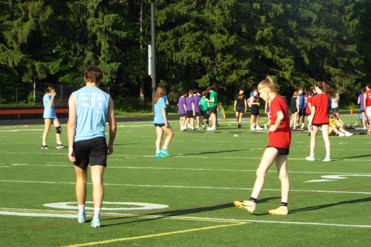 Houses warm up for an event on the field during House Games day.