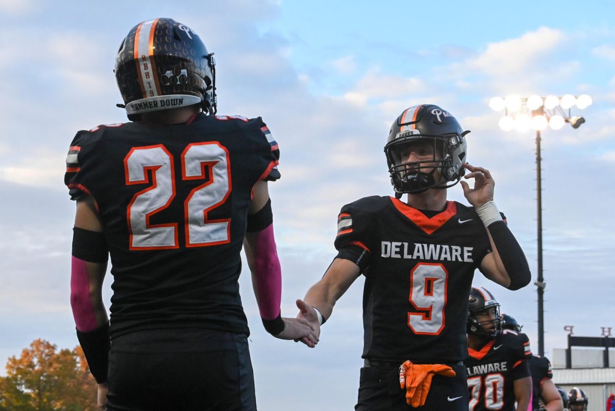 Seniors Garrett Brown and Connor Murphy high five each other during stretches.