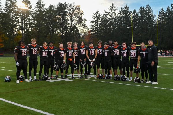 The football seniors pose for a picture together.