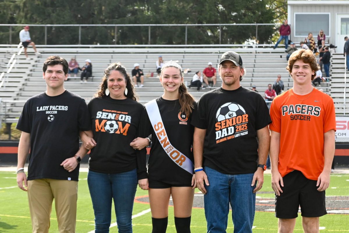 Elise Buckerfield walks with her family during the 2024 Lady Pacers Soccer senior day.