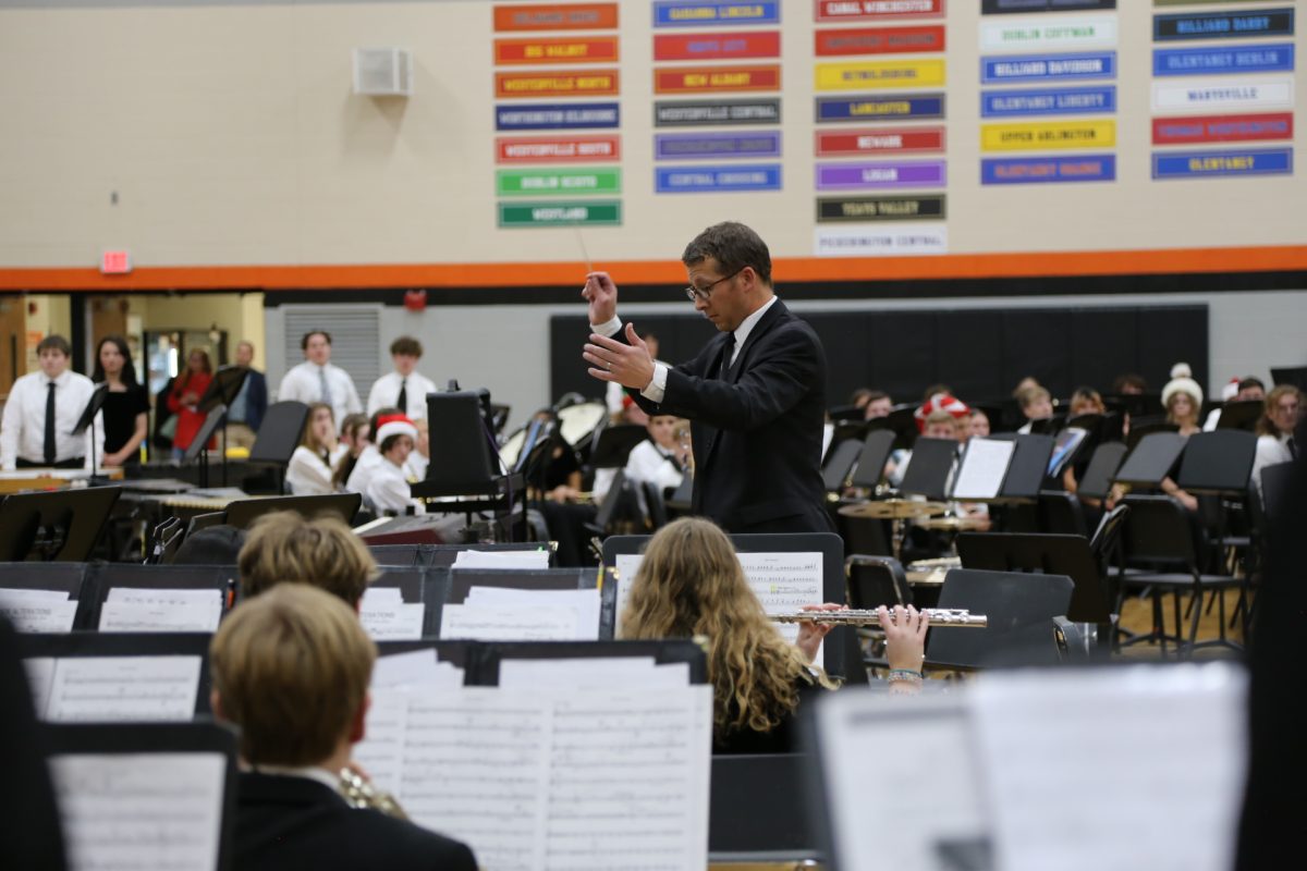 Fowles conducts the Hayes Symphonic Band during their playing of "Minor Alterations: Christmas Through The Looking Glass."