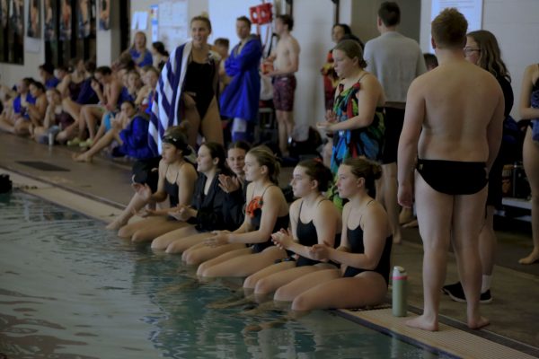 Pacer swimmers support their teammates during the diving portion of the meet. 