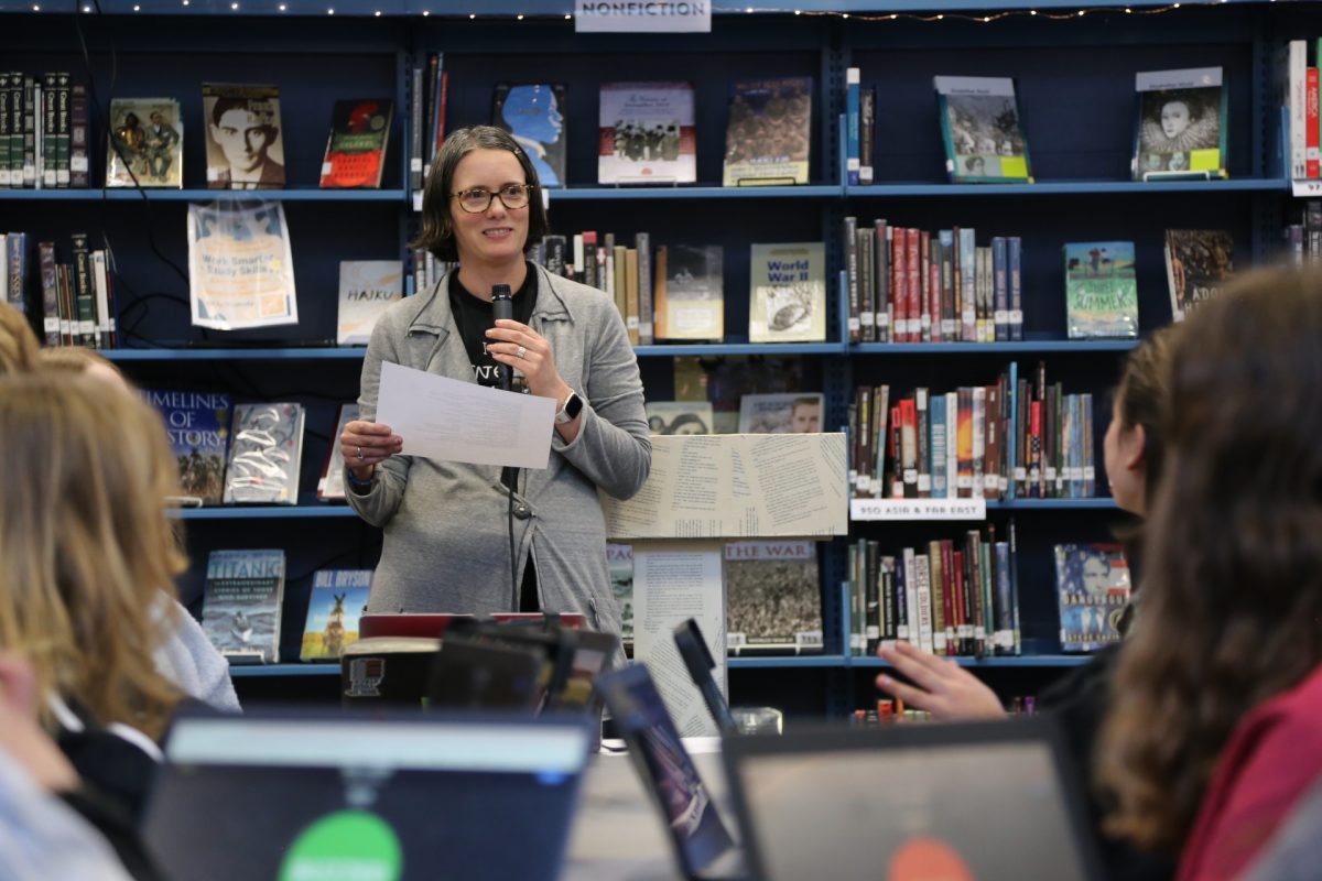 Librarian Sarah Ressler reads off practice questions for the first round.