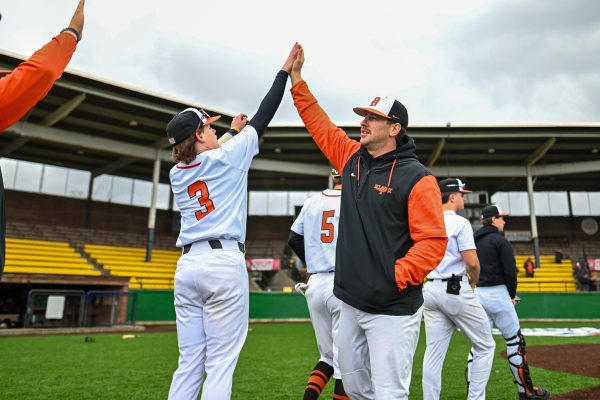 Head Coach David Meikrantz and Mowry high five each other after the game.