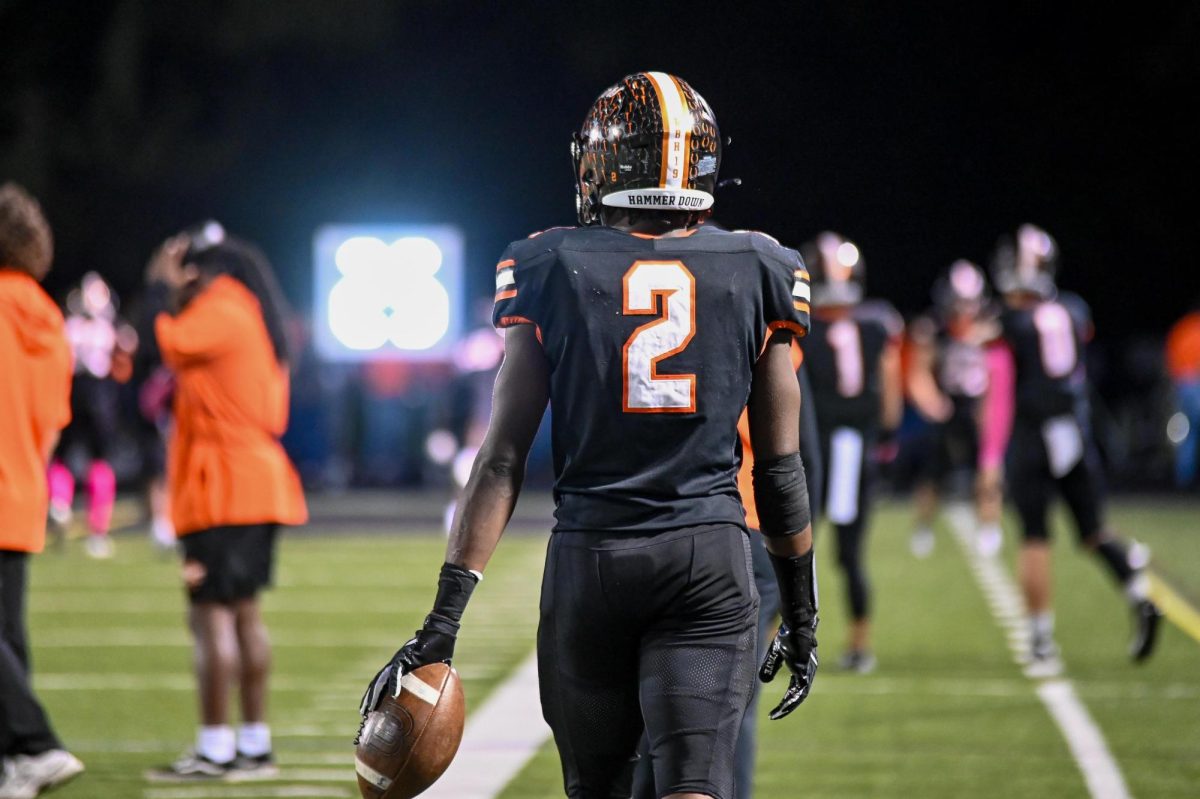 Junior Favour Akih walks back onto the field following half time.