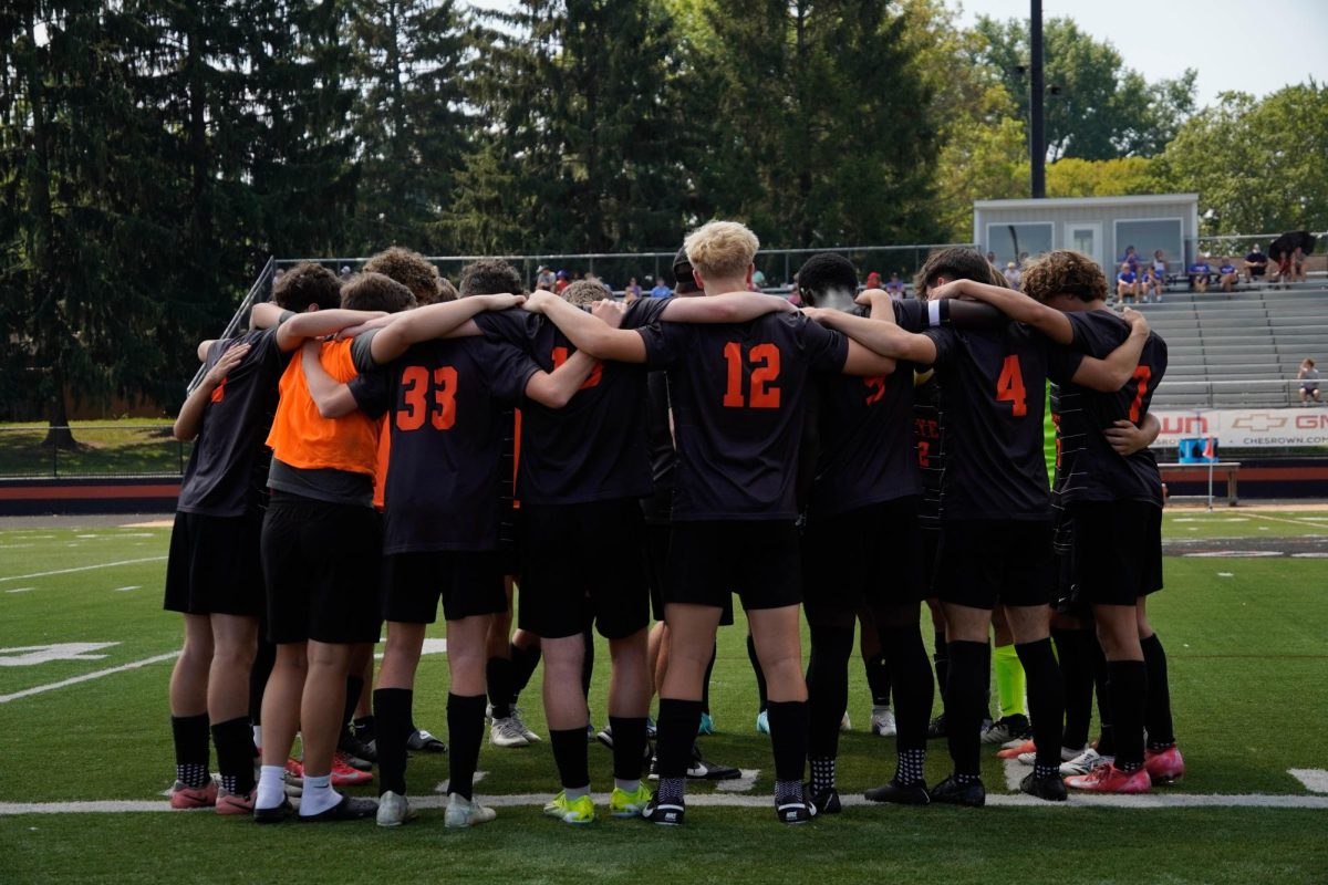 The soccer team huddles before the game.
