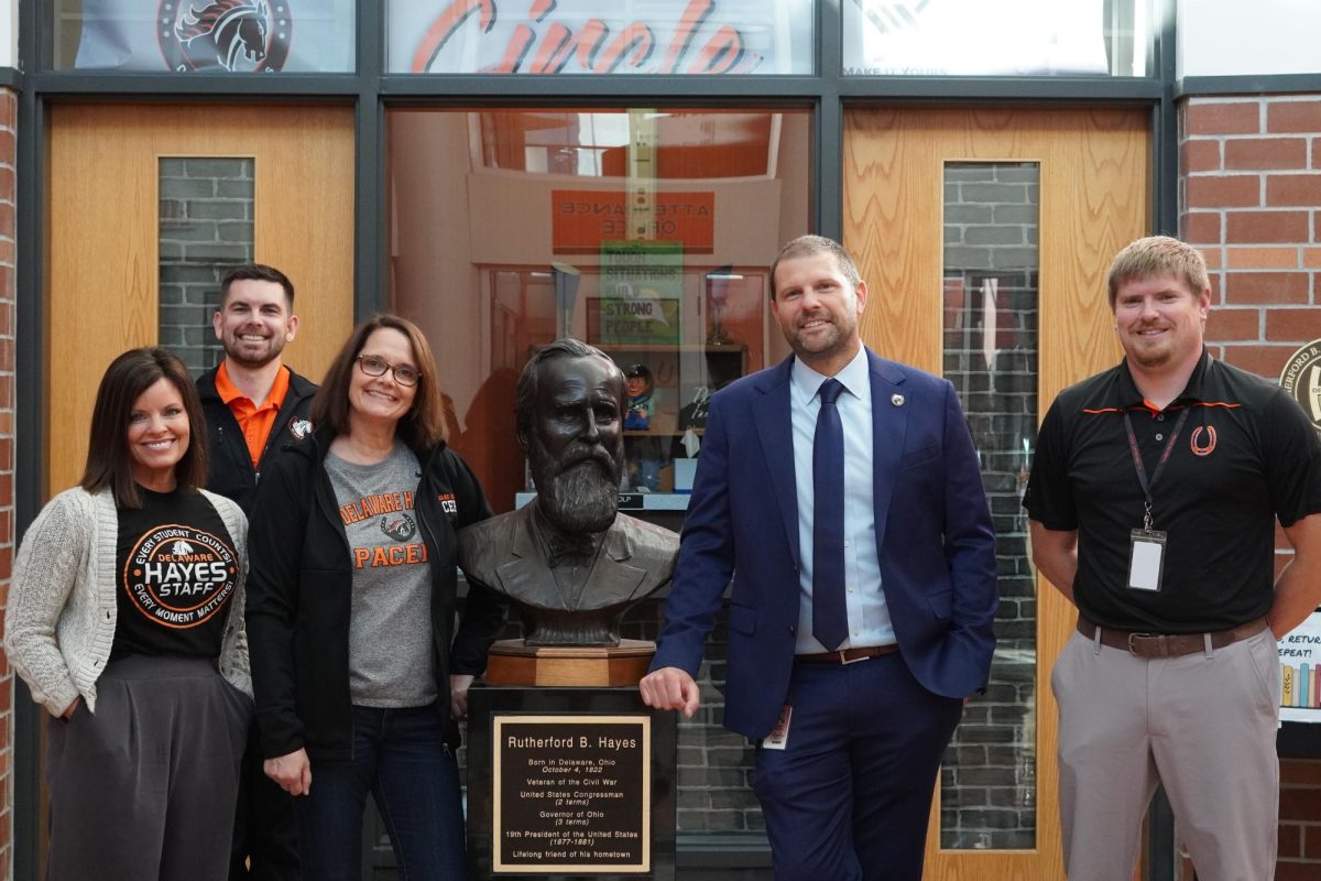 This year's administrative team poses for a picture next to the statue of Rutherford B. Hayes.