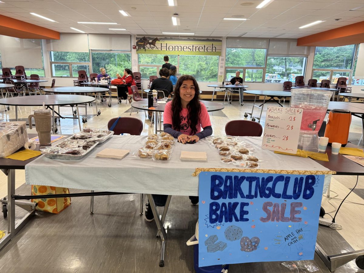 Junior Josie Rizo sells baked goods for a Baking Club fundraiser during House Games day last spring.