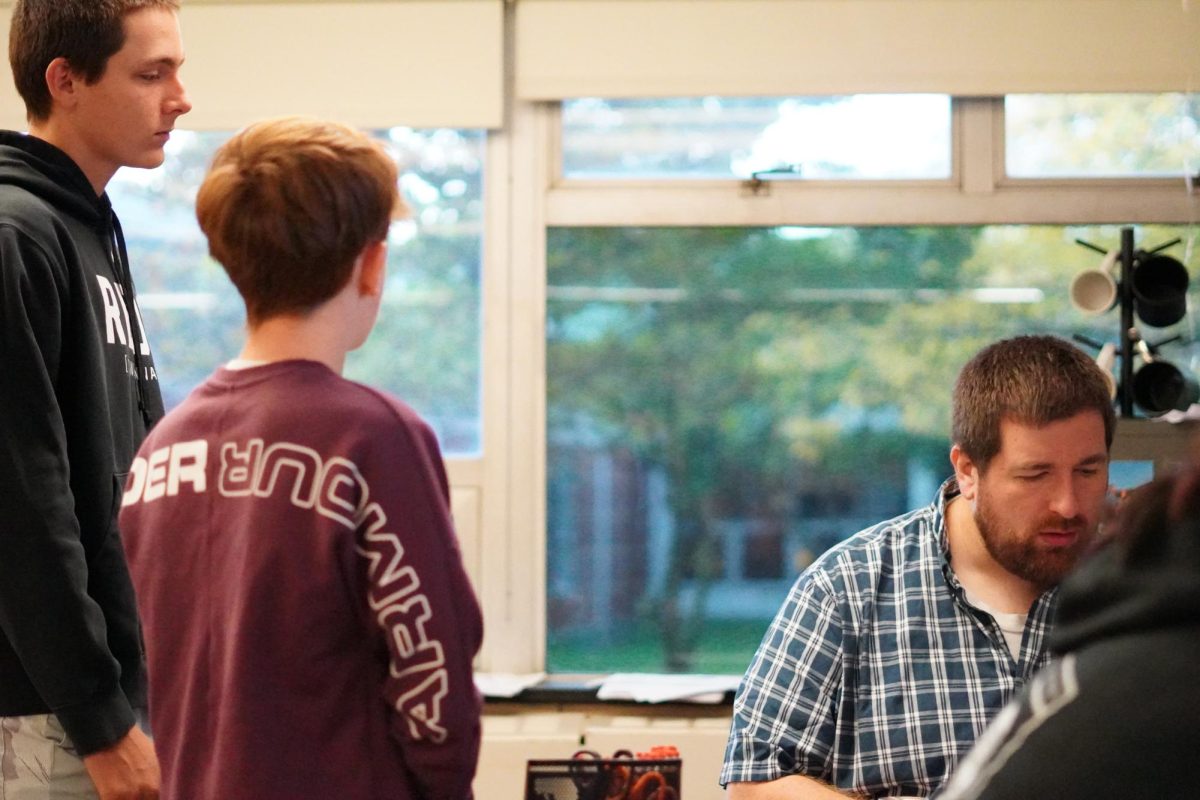 New teacher Ben Brown helps students in his World History class.
