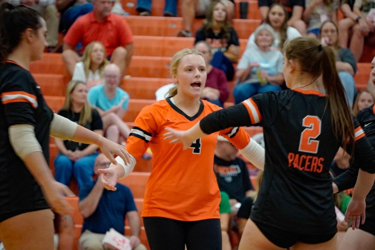 Senior Lizzy Gould celebrates with her team after a point.