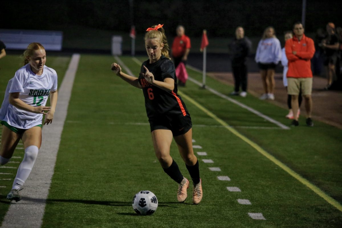 Freshman Chloe Artemus pushes the ball towards the goal.