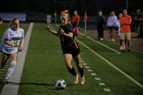 Freshman Chloe Artemus pushes the ball towards the goal.