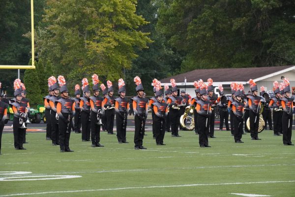 The Hayes Marching Band prepares to perform before the football game against Westland on Senior Night.