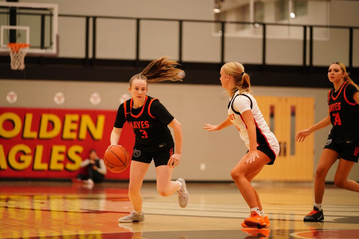 Freshman Mallory Madden dribbles into the paint.
