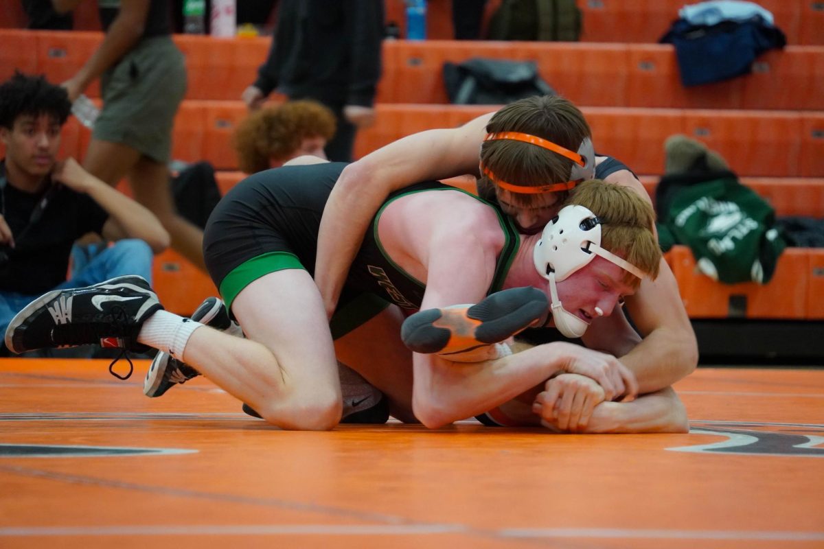 Cox grabs his opponent to flip him over.