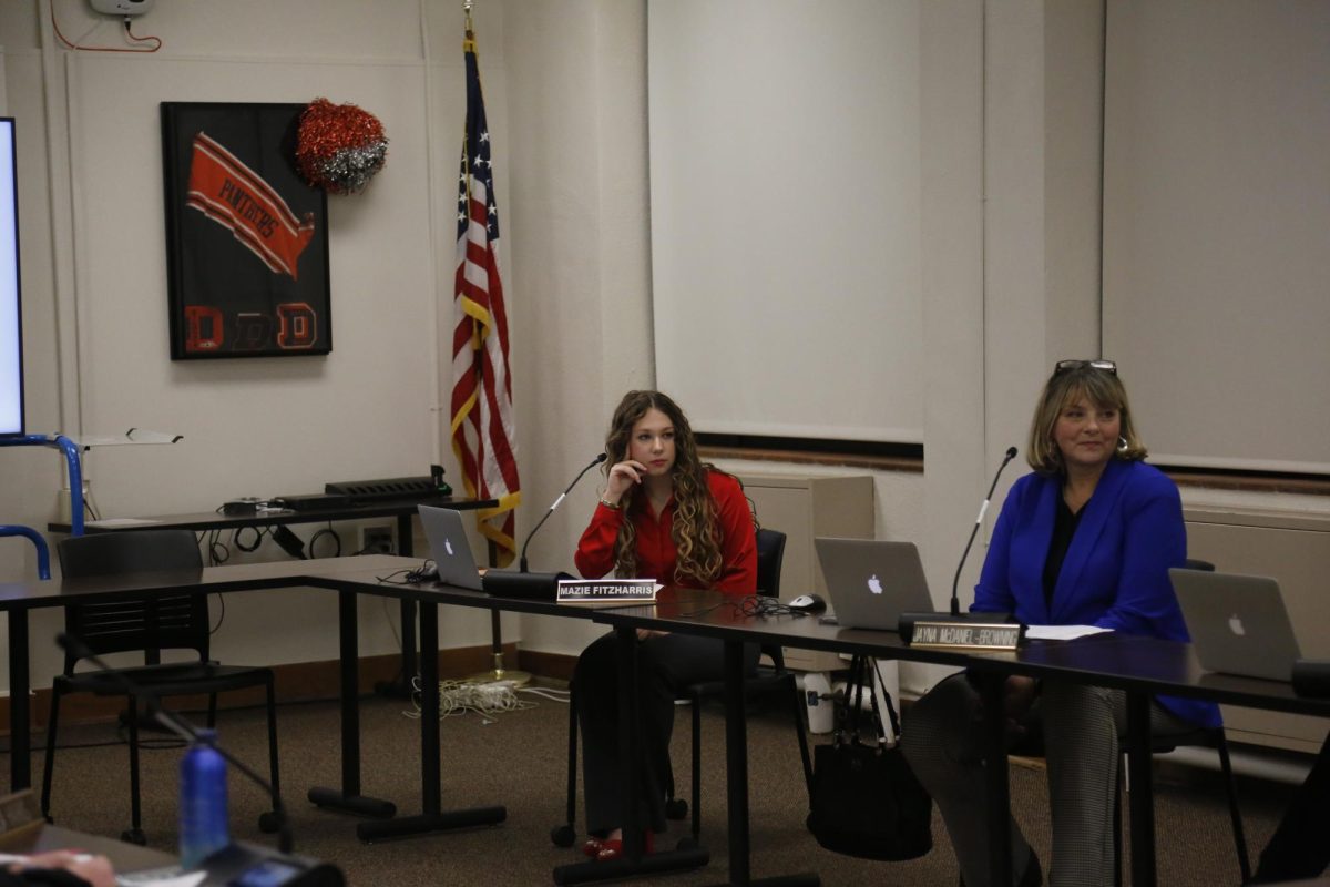 Senior Mazie Fitzharris listens in on a  meeting, performing her role as student school board representative.