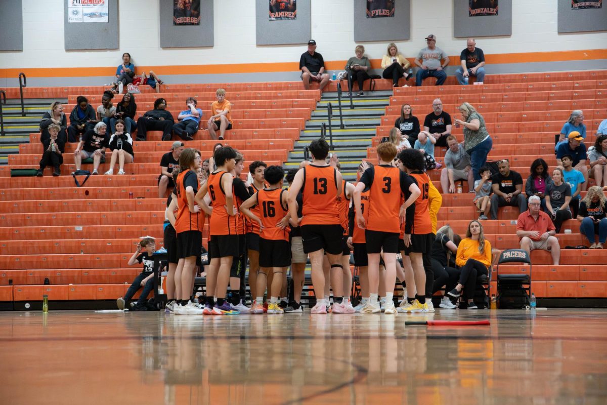 The team huddles after the first set.