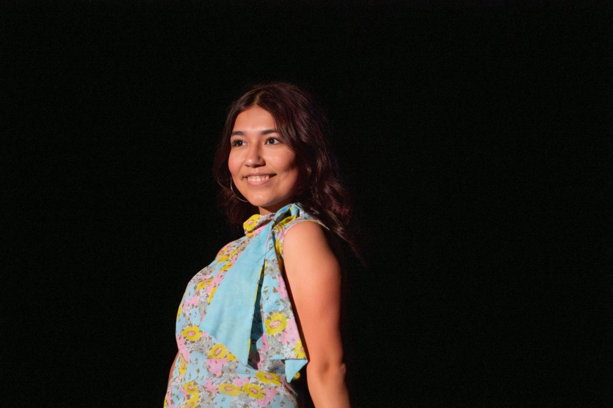 Junior Josie Rizo smiles in her floral dress.