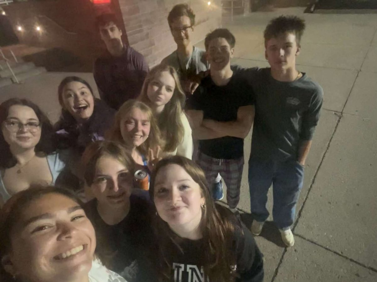 Brody Counts (back middle) with other members of the 2024-2025 Talisman staff after watching the movie "Trap".